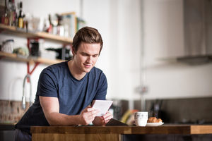 Young male reading card