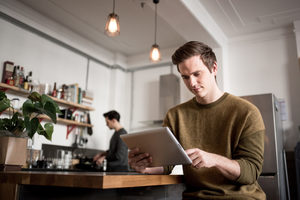 Young male using digital tablet at home