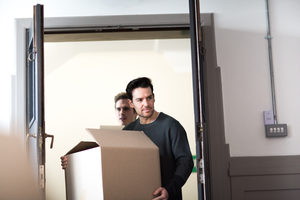 Young male couple moving home
