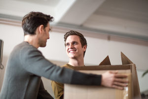 Young male couple moving home