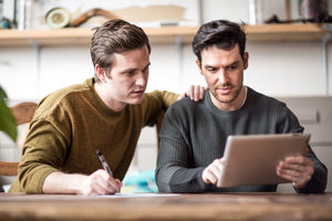 Young male couple completing mortgage application