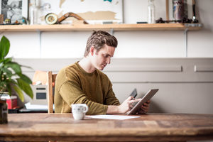 Young male with digital tablet and application