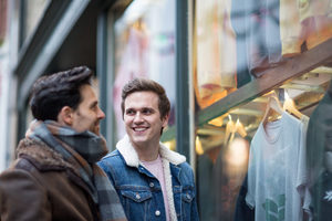 Young male couple window shopping