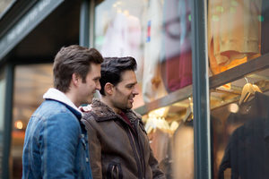 Young male couple window shopping