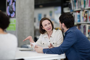 Mature students in library studying together