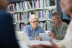 Senior woman learning how to use digital tablet