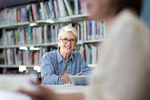 Portrait of mature student in college library