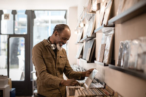 Senior Male looking for records in a store