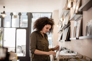 Young adult female looking for records in a store