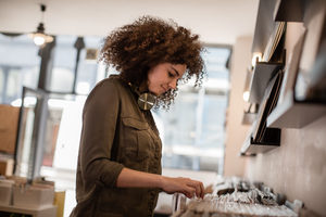 Closeup young adult female looking for records in a store