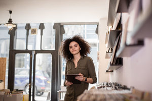 Portrait of small business owner holding digital tablet