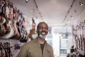 Portrait of a small business owner in a guitar store