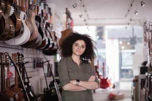 Portrait of a small business owner in a guitar store
