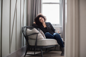 Young adult female relaxing at home with coffee