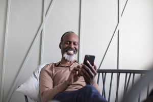 African American senior male using smartphone