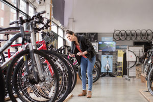 Small business owner stock taking in a bike store