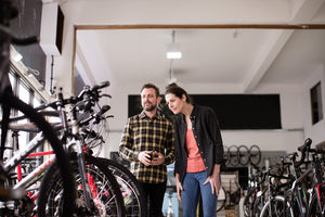 Small business owner serving customer in a bike store