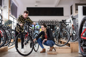 Small business owner helping customer in a bike store