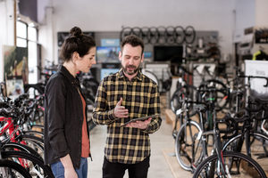Small business owner serving customer in a bike store