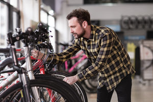Adult male choosing a bike in a cycle store