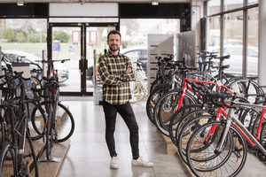 Portrait of a small business owner in a cycle store