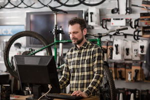 Small business owner using computer in a store