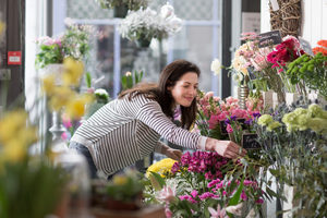 Adult female choosing flowers in a florist