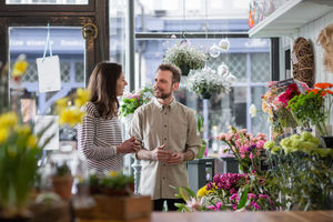 Florist serving customer in a store