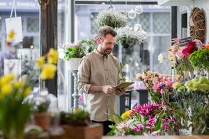 Small business owner using digital tablet in a florist
