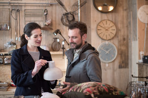 Couple looking at price tags in a home store