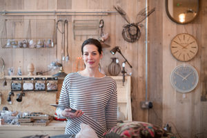 Portrait of small business owner holding digital tablet in a home store