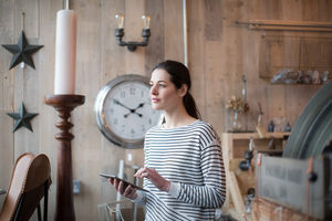 Small business owner using digital tablet in a store