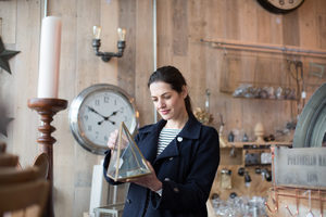 Adult female shopping in a vintage antique store