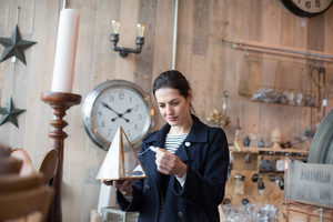 Adult female looking at price tags in a vintage antique store