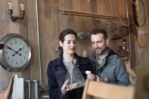 Couple looking at price tag in a home store