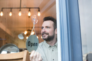 Small business owner opening store
