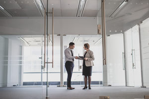 Businessman shaking hands with relator in new office space