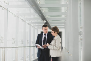 Business people having meeting in modern office using digital tablet