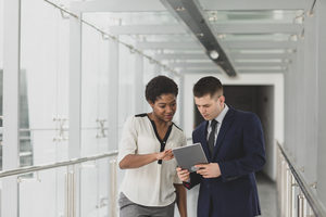 Business people having meeting in modern office using digital tablet