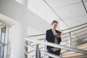 Businesswoman using smartphone in modern office