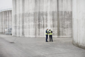 Industrial workers using a digital tablet on site