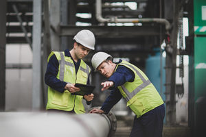 Industrial workers using a digital tablet on site