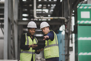 Industrial workers using a digital tablet on site