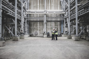 Industrial workers using a digital tablet on site