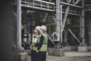 Industrial workers using a digital tablet on site