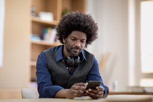 Businessman using smartphone at desk