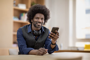 Portrait of businessman holding smartphone
