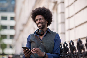 African American male using smartphone outdoors