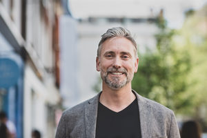 Portrait of smiling mature male outdoors in city