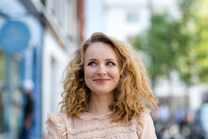 Adult female thinking outdoors in city